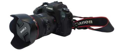 A Canon EOS 5D mark 2 camera, DS126201, together with a Canon EF24-105mm lens, with hood and canvas camera case, with charger.