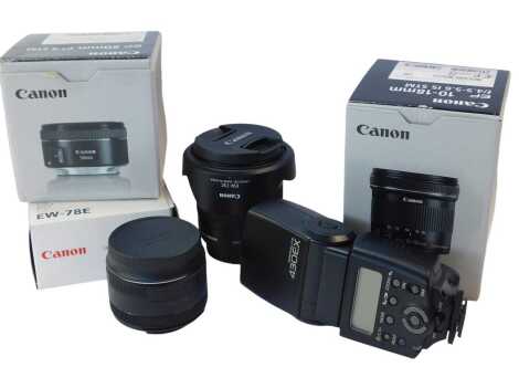 A Canon 50mm lens, f-1.8stm, together with a Canon 10x18mm lens, f/4.5-5.6 IS STM, boxed, a Canon Speed Light 430EX flash, and lens hood.