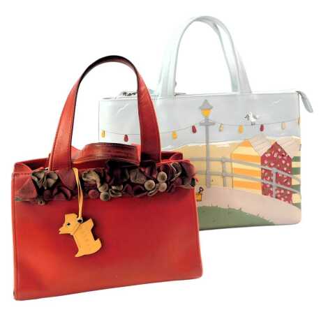 A Radley pale blue leather tote bag, decorated with a scene depicting a Scotty dog seated on a deckchair before a beach, 22cm x 32cm, together with a red leather Radley top handle bag, with suede floral top decoration, 17cm x 22cm. (2)