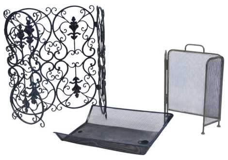 A Victorian wrought iron three fold fire screen, of scrolling form with leaf decoration, 70cm high, 68cm wide, 133cm wide extended, together with a brass three fold fire screen and a metal fire guard.