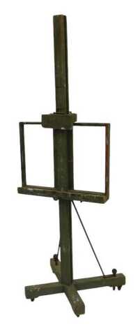 An artist's easel, painted in green, on a X shaped base, 189cm high.