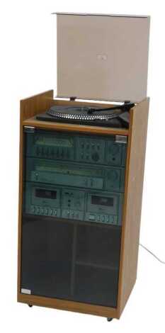 An Amstrad music system, comprising stereo amplifier, stereo tuner, double cassette deck and turntable, in cabinet, 90cm high, 42cm wide, 38cm deep.