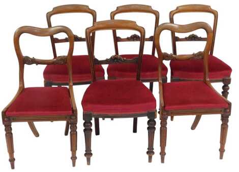 A set of four Victorian mahogany balloon back dining chairs, with carved rail, overstuffed seat, on turned and fluted legs, together with a pair of Victorian mahogany balloon back chairs, with leaf carved rail, drop in seat and turned fluted legs with rou