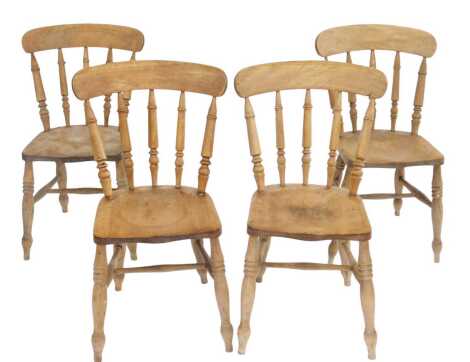 A set of four beech kitchen chairs, each with a turned spindle back, solid seat, on turned legs united by H shaped stretcher.