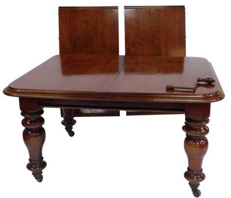 A Victorian mahogany extending dining table, the top with a moulded rounded edge, raised on turned cylindrical legs on castors, 73cm high, the top 111cm x 197cm, with leaf. 197cm with leaf, without leaf 134cm.