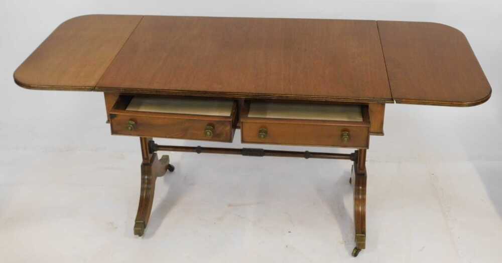 A mahogany sofa table, the drop leaf top with a rounded edge above two