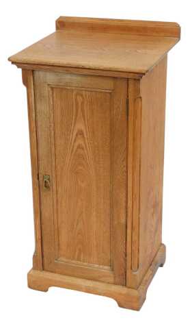 A late 19th oak pot cupboard, with raised back, moulded top above a panelled door enclosing shelf, on bracket feet, 87cm high, 44cm wide, 40cm deep.