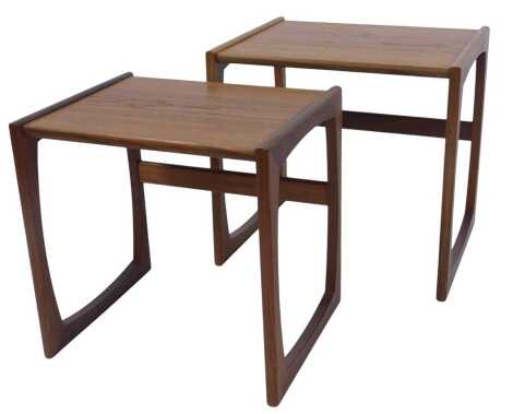 A 1970s teak nest of two tables, on U shaped supports, the largest 46cm high, 48cm wide, 39cm deep.