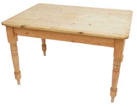 A Victorian pine kitchen table, rectangular top with a rounded edge, on turned legs, 74cm high, the top 117cm x 85cm.