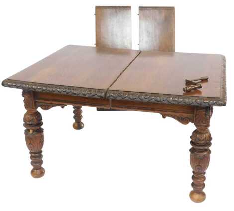 A 20thC oak dining table, the rectangular top with a leaf carved edge, on leaf carved turned legs, 75cm high, the top 131cm x 105cm, with two additional leaves each measuring 36cm wide.