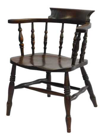 A 19thC country made elbow chair, with scroll arms, turned spindle back, solid seat, on turned legs with double H stretcher.