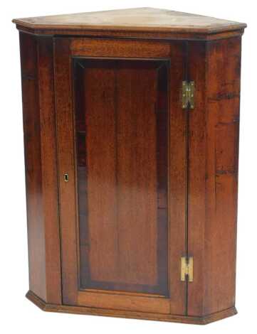 A 19thC oak corner cabinet, the top with a moulded cornice above a panelled door enclosing two shelves, on a moulded base, 89cm high, 73cm wide, 40cm deep.