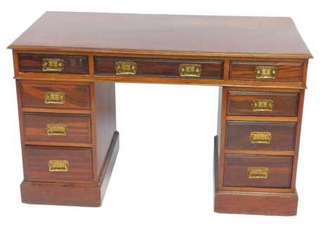 An early 20thC mahogany pedestal desk, the rectangular top above an arrangement of nine drawers, on a plinth base, 77cm high, 121cm wide, 60cm deep.