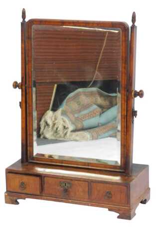 A late 19thC walnut swing frame mirror, the rectangular mirror plate above a base with an arrangement of three drawers, on bracket feet, 73cm high, 51cm wide, 22cm deep.