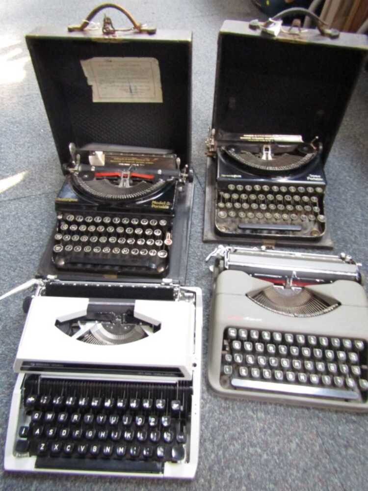 Four cased typewriters, to include Remington, Silver Reed, Empire