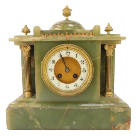 A late 19th/early 20thC green onyx mantel clock, the circular dial with cream enamel chapter ring bearing Arabic numerals, eight day, the case of architectural form, with key, 31cm high.