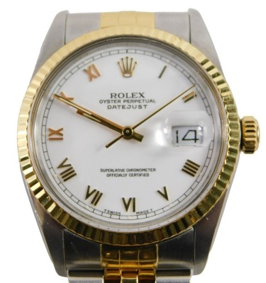 A gentleman's Rolex Oyster Perpetual Datejust wristwatch, model number 16013, with bi-metallic stainless steel and gilt case and bezel, white dial and Roman numerals, with bracelet strap, and original box, with original guarantee purchased 9th July 1988,