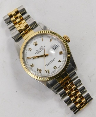 A gentleman's Rolex Oyster Perpetual Datejust wristwatch, model number 16013, with bi-metallic stainless steel and gilt case and bezel, white dial and Roman numerals, with bracelet strap, and original box, with original guarantee purchased 9th July 1988, - 2