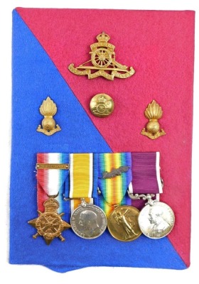 A WWI Royal Artillery medal group, comprising 1914 star, with 'Mons' clasp, 1914/18 British War Medal, Victory Medal, with oak leaf insignia (mentioned in dispatches) George V Long Service and Good Conduct Medal, inscribed to 6077 Bombardier E Seabrook, R