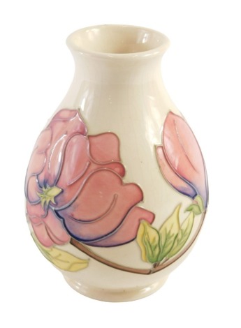 A Moorcroft Magnolia vase, of slightly flared ovoid design, with tube lined pink magnolia flower head buds, stamped Moorcroft to the base, and numbered 75194, 19cm high.