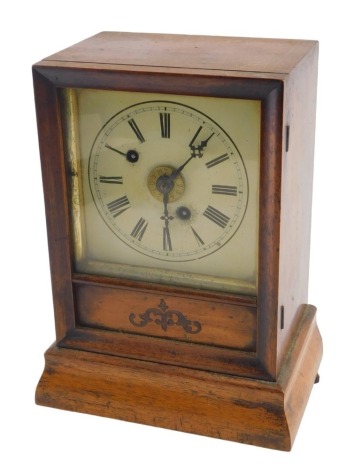 A late 19thC American style shelf clock, with striking movement, painted dial and Roman numerals, bears label to the inside door case for Ganter Brothers Watch & Clock Manufacturers, Essex Quay, Dublin, in a veneered plain case, 25cm high.