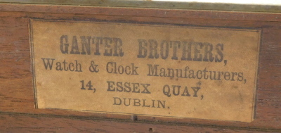 A late 19thC American style shelf clock, with striking movement, painted dial and Roman numerals, bears label to the inside door case for Ganter Brothers Watch & Clock Manufacturers, Essex Quay, Dublin, in a veneered plain case, 25cm high. - 3