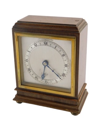 An Elliott mantel clock, in mahogany case, with silvered chapter ring and Roman numerals, 15.5cm high, with instructions.