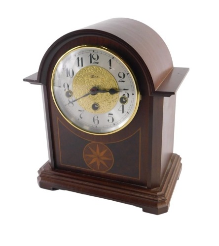 A Hermle mantel clock, with eight day striking and chiming movement, with Arabic numerals, and mahogany and burr walnut inlaid case, 25.5cm high, with two keys.