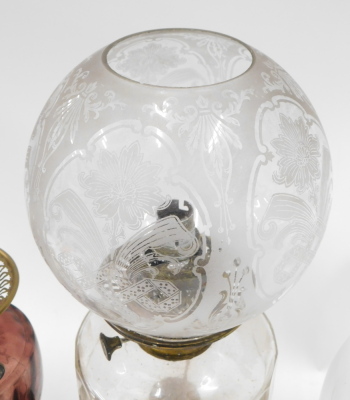 Two Victorian brass table lamps, with Duplex burners, and glass reservoirs, one with an acid etched shade, and fitted for electricity, and a brass oil lamp, with opaque white shade, and two small chamber oil lamps, with glass reservoirs and handles. (5) - 3