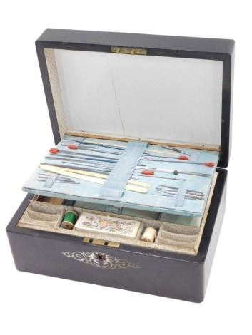 A Victorian ebonised work box, with mother of pearl inlay, the fitted interior with blue silk lining, padding, and papered lining, with various mother of pearl implements, bone bobbin thread winders, etc., and a small needlework sampler, 11cm high, 25cm w