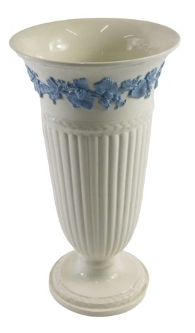 A Wedgwood embossed Queensware vase, of tapered semi-fluted design, with banded border of raised blue fruiting vine decoration, 28cm high.