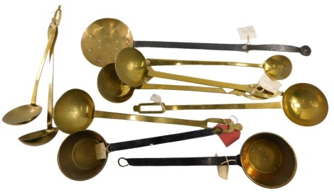 A collection of brass ladles and a skimmer. (10)