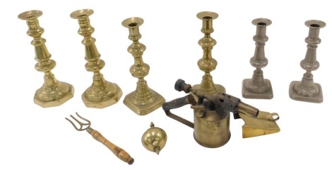 Brass candlesticks and blowtorch, etc., comprising various brass candlesticks, clock ball ornament, three pronged fork, etc. (1 tray)