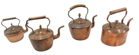 Four various copper kettles.