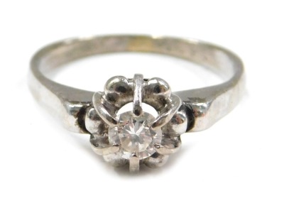 A diamond solitaire dress ring, the diamond approx 0.50ct, in a raised six claw setting with floral border, on a plain band, unmarked, ring size J, 3.2g all in.