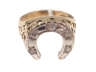 A 9ct gold horse shoe dress ring, the shaped horse shoe in a white gold setting, set with five tiny diamonds, on pierced shoulders, ring size V, 4.7g all in.