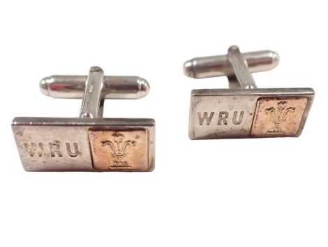 A pair of Glogau cuff links, each of rectangular form with Prince of Wales feathers and bearing the initials WRU, for The Welsh Rugby Union white and yellow metal, unmarked, 10g all in, boxed.