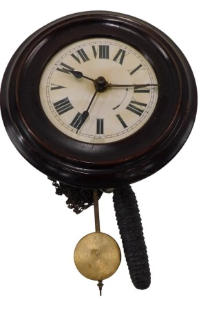 A 19thC postman's alarm wall clock, with white dial and Roman numerals, within a mahogany stained circular bezel case, striking on a belt at the top, 26cm diameter overall.