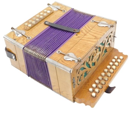 A DRGM soberano accordion, with thirty-four stops, in simulated pine case, and with fibre carrying case.