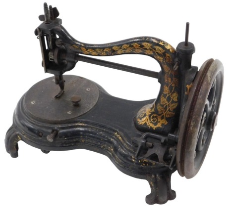 A Victorian cast iron hand sewing machine, with black Japanned and gilt decoration, the machine terminal with brass plate, inscribed patent hand sewing machine.