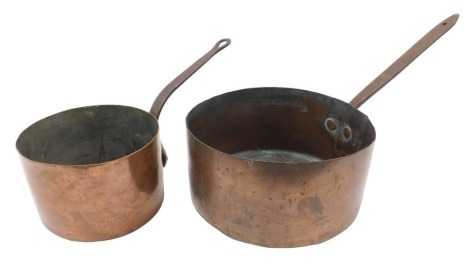 Two copper saucepans, with iron handles, the largest 28cm diameter.