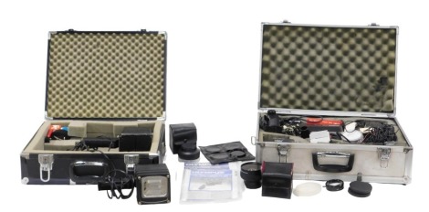 An Olympus VX303 video camera, with accessories in fitted aluminium carry case, and two hand held lighting lamps, in a case. WARNING! This lot contains untested or unsafe electrical items. It is supplied for scrap or re-conditioning only. TRADE ONLY