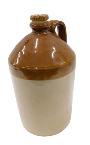 A large three gallon stoneware flagon, with treacle glaze, strap handle and screw cap, fitted for a tap, indistinct impress marks to the shoulder, 45cm high.