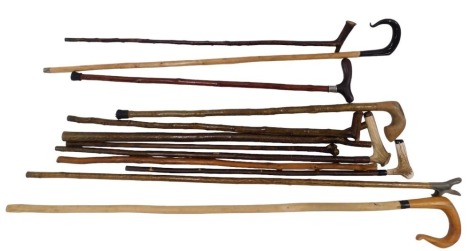 A collection of walking sticks and thumb sticks, some with antler handles. (12)