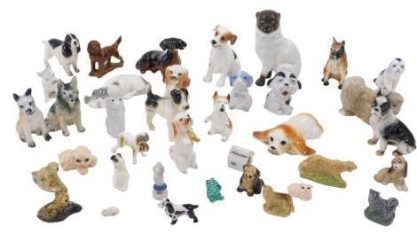 A collection of ceramic model dogs, including a Continental porcelain model of a seated Pug, Doulton terrier (AF), Spaniel, Dachshund, Wade dogs and animals, etc. (1 tray, some AF)