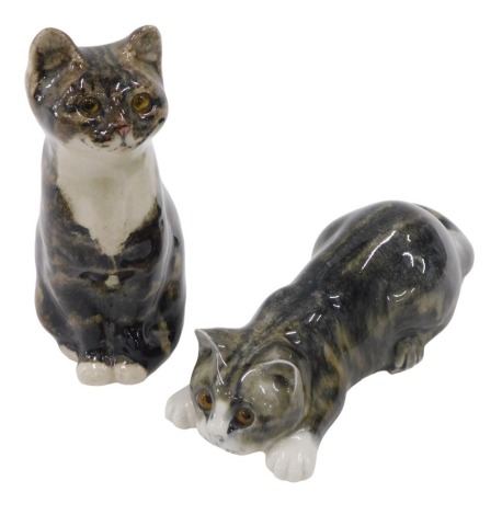 Two model pottery tabby cats, with running mottle glazed decoration, one signed by Mike Linton, 24cm long, the other seated cat with indistinct marks, 20.5cm high.