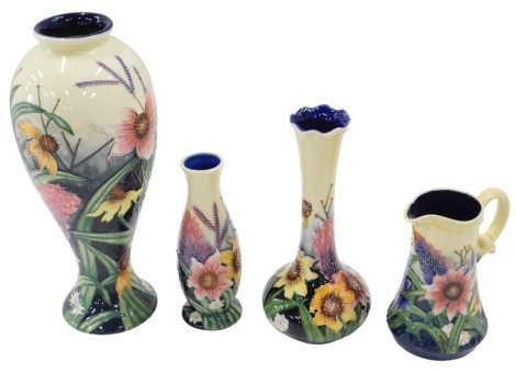 Three modern Old Tupton ware vases and a jug, each with tube lined floral decoration, in varying shapes and sizes, the tallest vase measures 27.5cm high.