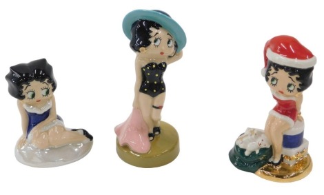 Three Wade Betty Boop figures, including Beach Belle, 15cm high, Christmas Prize, 13.5cm high, and a seated Betty Boop figure, 10cm high.