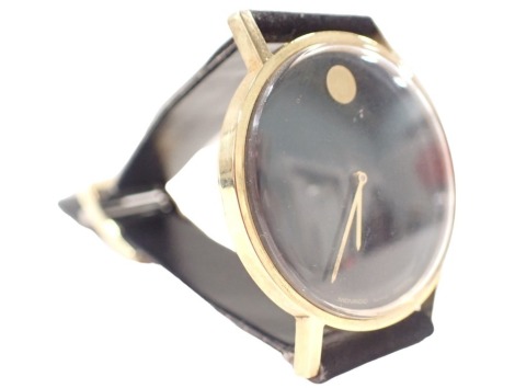 A Movado Zenith wristwatch, in a yellow metal case, stamped 14k, numbered 36 0420 357, with black ceramic face, 3cm diameter, on a velvet type strap, 28.9g all in, boxed.