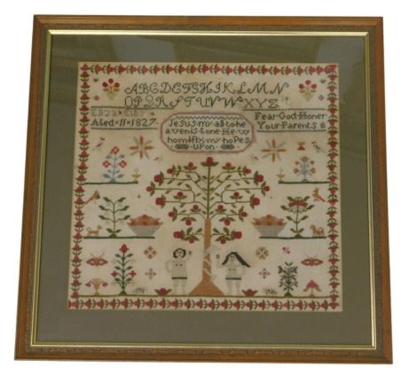 A 19thC silk needlework sampler, with religious text, alphabet and motto, by Elizabeth Ellis aged 11, 1827, within a border of flower bud decoration and with Adam and Eve and other flowering shrubs and motifs, 42cm x 42cm.